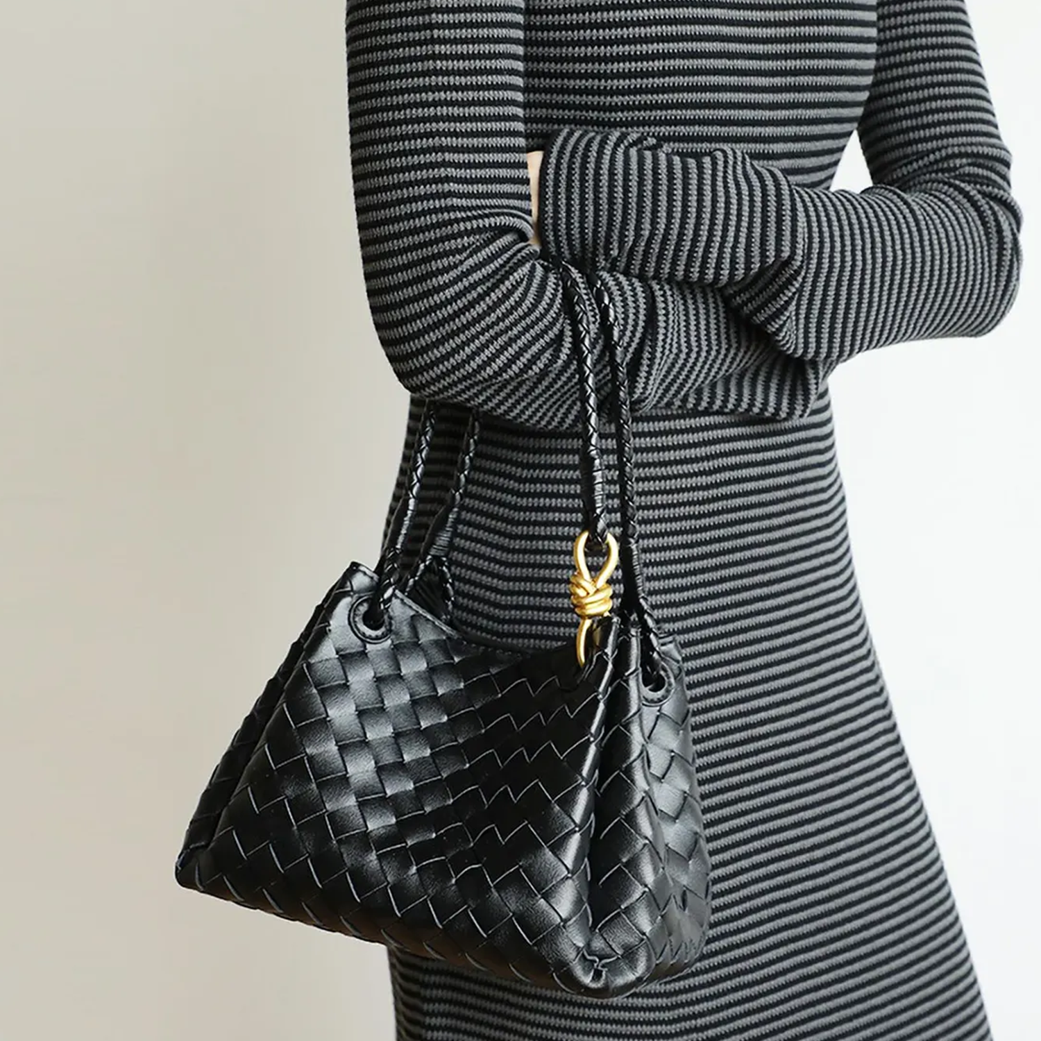 Dense Grid Woven Sloped Tote With Braided Twisted Top Handles, Knotted Golden Central Clasp And Extra Single Hanging Strap