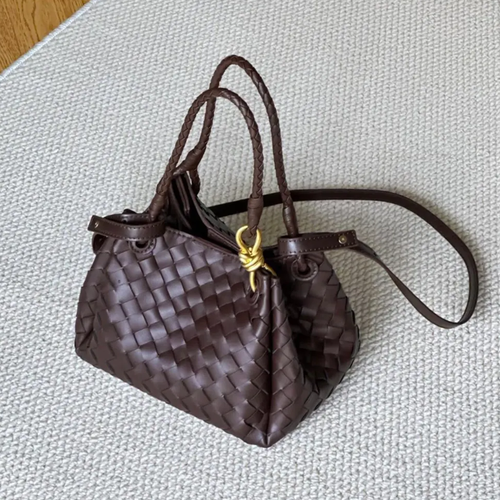 Dense Grid Woven Sloped Tote With Braided Twisted Top Handles, Knotted Golden Central Clasp And Extra Single Hanging Strap